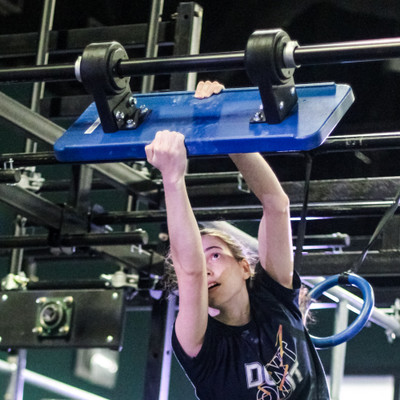 Blue Swinging Unstable Bridge on rig in use by athlete